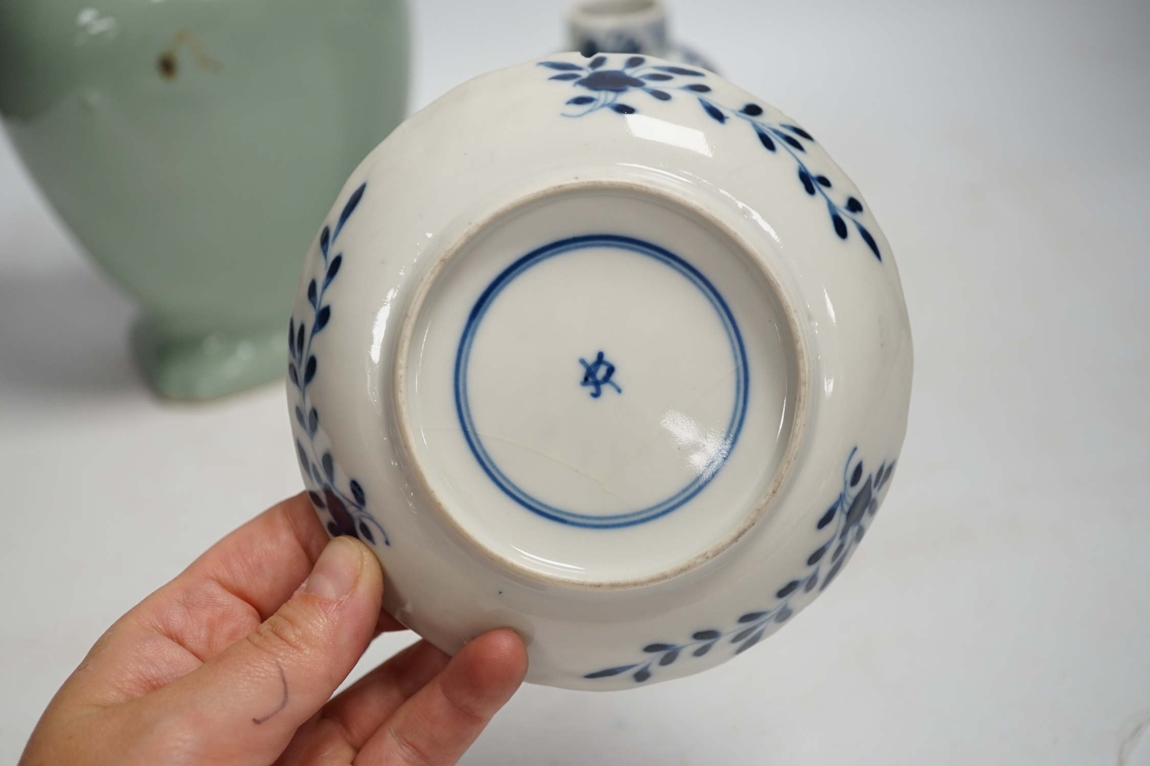 A Chinese celadon glazed two handled vase and a Chinese blue and white vase and dish, celadon vase 28.5cm high. Condition - celadon vase has a firing flaw and large crack, both blue and white vase are in damaged conditio